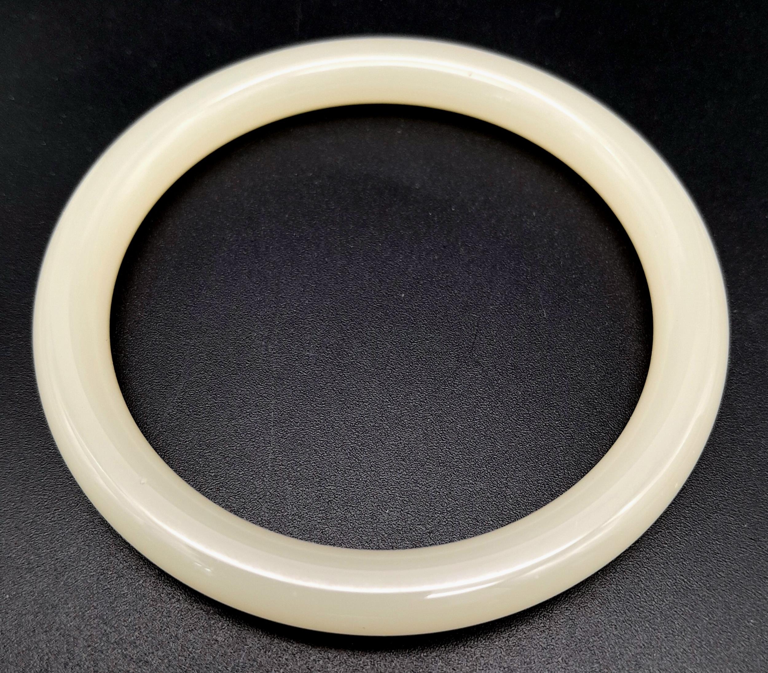 A Light Pastel Shade Thin Jade Bangle. 8mm width. 6cm inner diameter. - Image 3 of 3