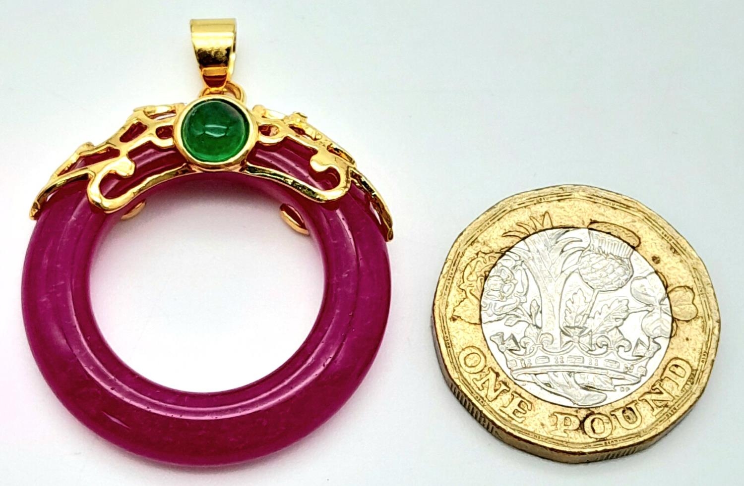 A Magenta Jade Pendant on Gilded Backing. 4cm length, 3cm diameter, 6.79g total weight. - Image 4 of 4