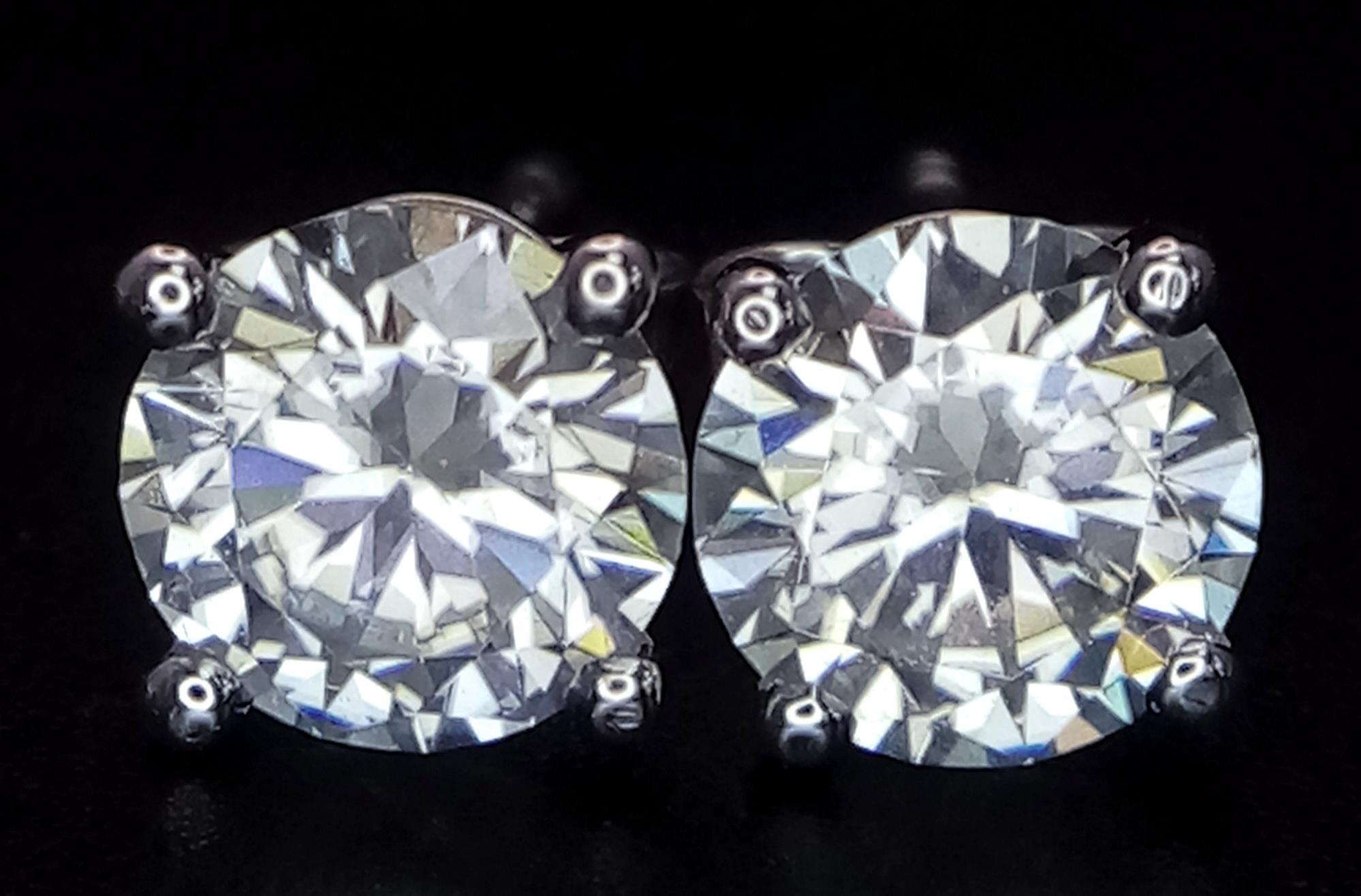 A Pair of 1ct Moissanite Earrings on 14K White Gold. Both stones come with a GRA certificate. 1.3g