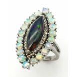 A 2ct Black Opal Marquise Shaped Ring with 1.80ctw White opal surround and .40ctw of Diamond