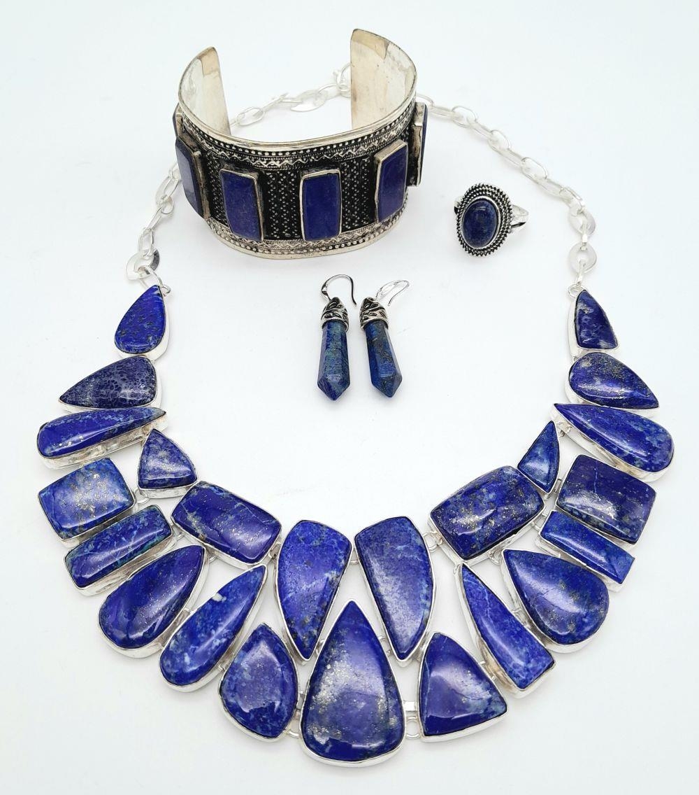 A Lapis Lazuli Jewellery Suite: Necklace, cuff bangle, ring - size S and a pair of drop earrings.