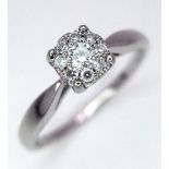 An 18k White Gold Diamond Ring. 2.6g total weight. 0.15ct diamond. Size L.