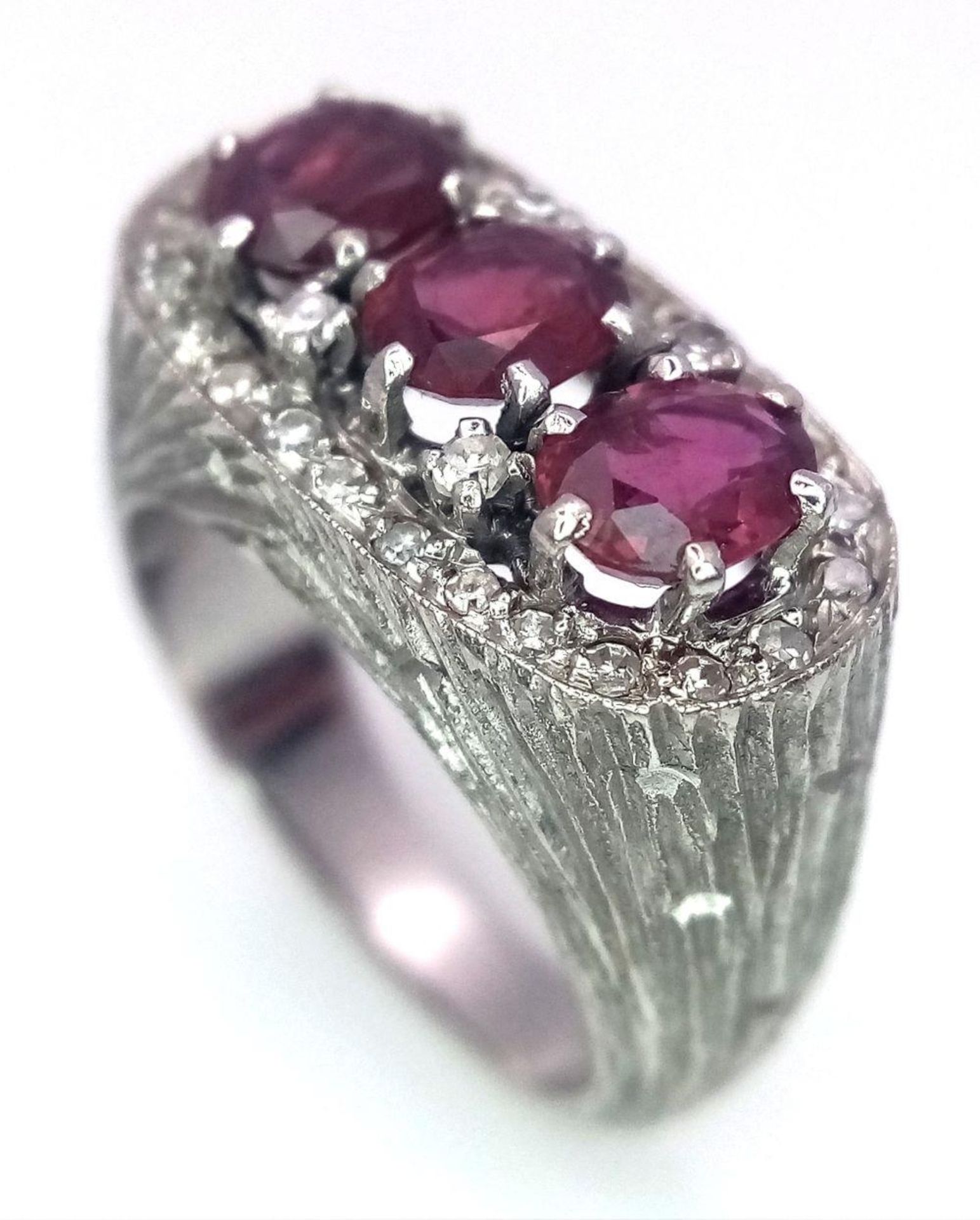 A 14K WHITE GOLD DIAMOND & RUBY RING. 3 X OVAL RUBIES, TOTAL 1.50CT. Size J 1/2 , 8.5G TOTAL WEIGHT.