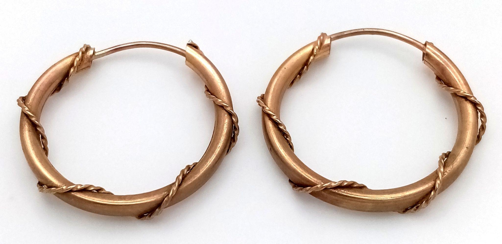 A Pair of 9K Yellow Gold Nautical-Esque Hooped Earrings. 2cm diameter. 1.3g weight.