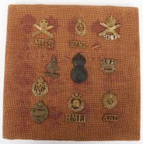 Assortment of British Military cap badges and shoulder titles