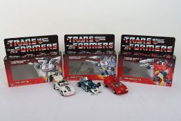 Three Vintage G1 Transformers Autobot Jazz boxed, Autobot Spy Mirage boxed, Sideswipe boxed Takara H