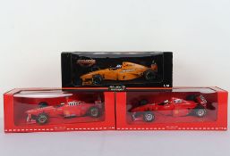 Three McLaren Collection MInichamps Ms Collection Formula One 1:18 Scale Model Cars.