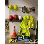 Lot of industrial safety and PPE gear, including cones, tape, gloves, vests, and safety headgear-