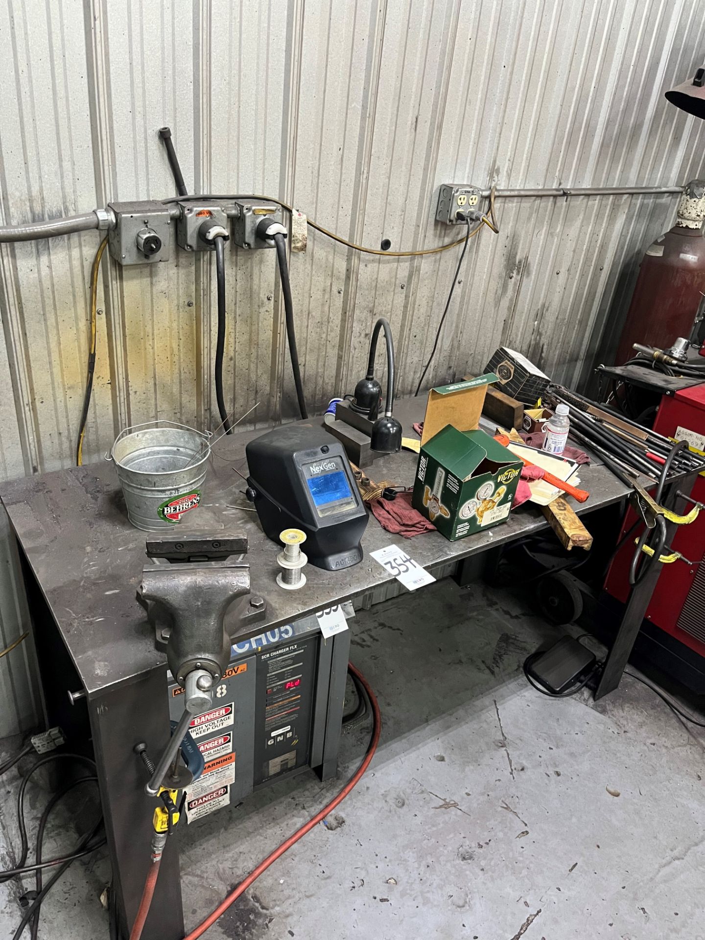 Metal shop table with vise and welding accessories