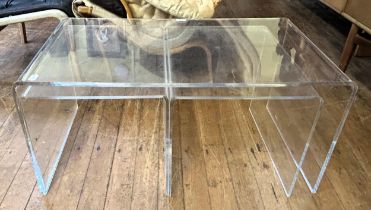 A nest of three clear plastic tables, 90 cm wide