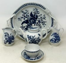 An 18th century Worcester blue and white teapot, 13 cm high, two cream jugs, a twin handled tray,