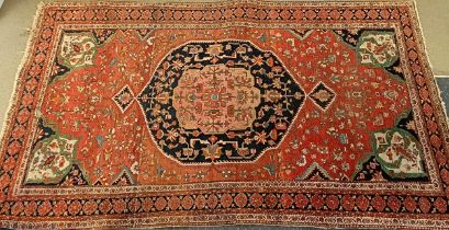A Tribal red ground rug, 230 x 160 cm Heavily worn, hole and tear. See images