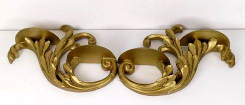 A pair of gesso wall brackets,of scroll form, 57 cm wide (2)