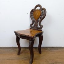 An unusual Swiss/Austrian marquetry inlaid and carved wood child's musical chair, decorated a bear