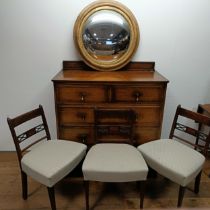 An oak chest, 107 cm wide, three dining chairs and a convex wall mirror, 70 cm diameter, a