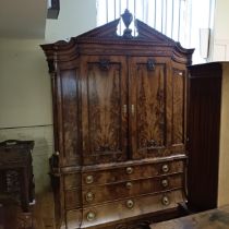 An 18th century Dutch armoire, with two cupboard doors to reveal shelf and drawers, on a base with