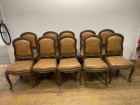 A set of ten French walnut dining chairs, with padded backs and drop in seats, on cabriole legs (10)