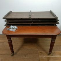 A 19th century mahogany extending dining table, on turned reeded legs to castors, with four extra