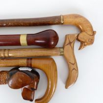A walking stick, the handle carved in the form of a dog, 38 cm, and four other walking sticks (5)