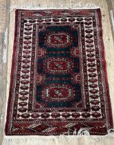 An Afghan type rug, the central green ground with three medallions 140 x 100 cm