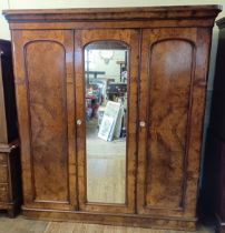 A 19th century walnut triple wardrobe, with a central mirror door, 185 cm wide overall in an