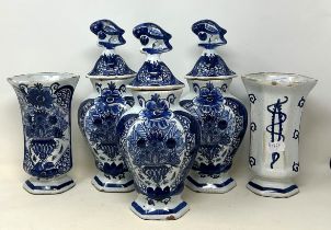 A Delft garniture, comprising three vases and covers, 34 cm high, and a pair of vases, 20 cm high (