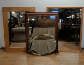 An oak wall mirror, 130 x 90 cm, an oval wall mirror, 65 x 80 cm, a mahogany wall mirror, 115 x 92