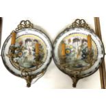 A pair of Delft polychrome plates, decorated garden scenes, made into a pair of wall sconces with