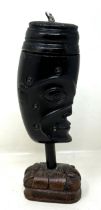 A carved horn bust, on a carved wooden base, possibly Australasian, 18 cm high