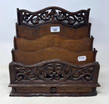 A Continental carved and pierced letter rack, decorated floral forms, 33 cm wide