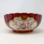 A Continental porcelain bowl, with a red ground, decorated flowers, highlighted in gilt, 34 cm