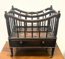 A 19th century mahogany Canterbury, with a brass handle, the base with a drawer, on turned legs to