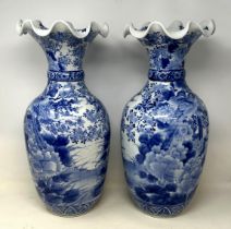 **Regretfully withdrawn**A pair of Japanese blue and white vases, decorated birds and flowers, 46 cm