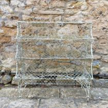 A painted wirework plant stand Weathered.