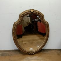 A gilt gesso wall mirror, of cartouche form, 80 x 96 cm