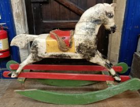 A vintage painted wooden rocking horse, 144 cm wide Paint very worn, in need of restoration