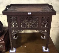 A carved Eastern folding table, decorated repeating foliate forms, 62 cm wide