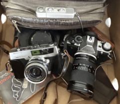 A Canon AE-1 camera, an Olympus lens, a Minox spy type camera, and assorted other photography