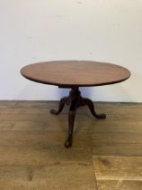 A mahogany wine table, on a column support to tripod base, 84 cm diameter Has been reduced in size