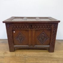 An 18th century oak coffer, of small proportions, with carved decoration, on stile legs, 84 cm wide