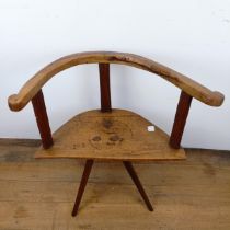 A child's primitive/country made chair, of triangular form on three legs