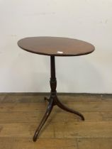 A 19th century mahogany oval wine table, on a column support to a tripod base, 56 cm wide