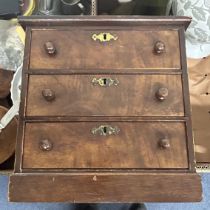 A mahogany table top chest, of three drawers, 28 cm wide, treen bowls and assorted other items (2