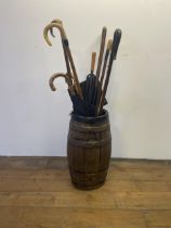 A metal bound stick stand, and assorted walking sticks