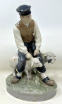 A Royal Copenhagen figure of a man with two sheep, 20 cm high No chips, cracks or restoration found