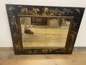 A wall mirror, with a lacquered frame in the Chinese manner, 80 x 60 cm