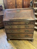 An 18th century oak and mahogany crossbanded bureau, the fall front revealing a well, drawers and