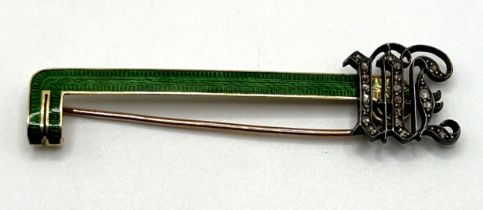 An early 20th century, yellow coloured metal and green enamel bar brooch, inset with white stones