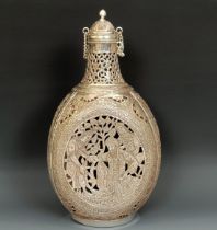 A Persian silver coloured metal and glass decanter, decorated figures, 25 cm high Overall