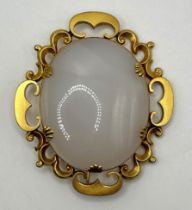 A yellow coloured metal and onyx oval brooch